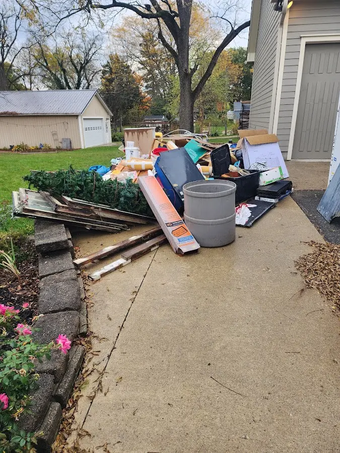 Dumpster being loaded with debris for Residential Dumpster Rental in Durham